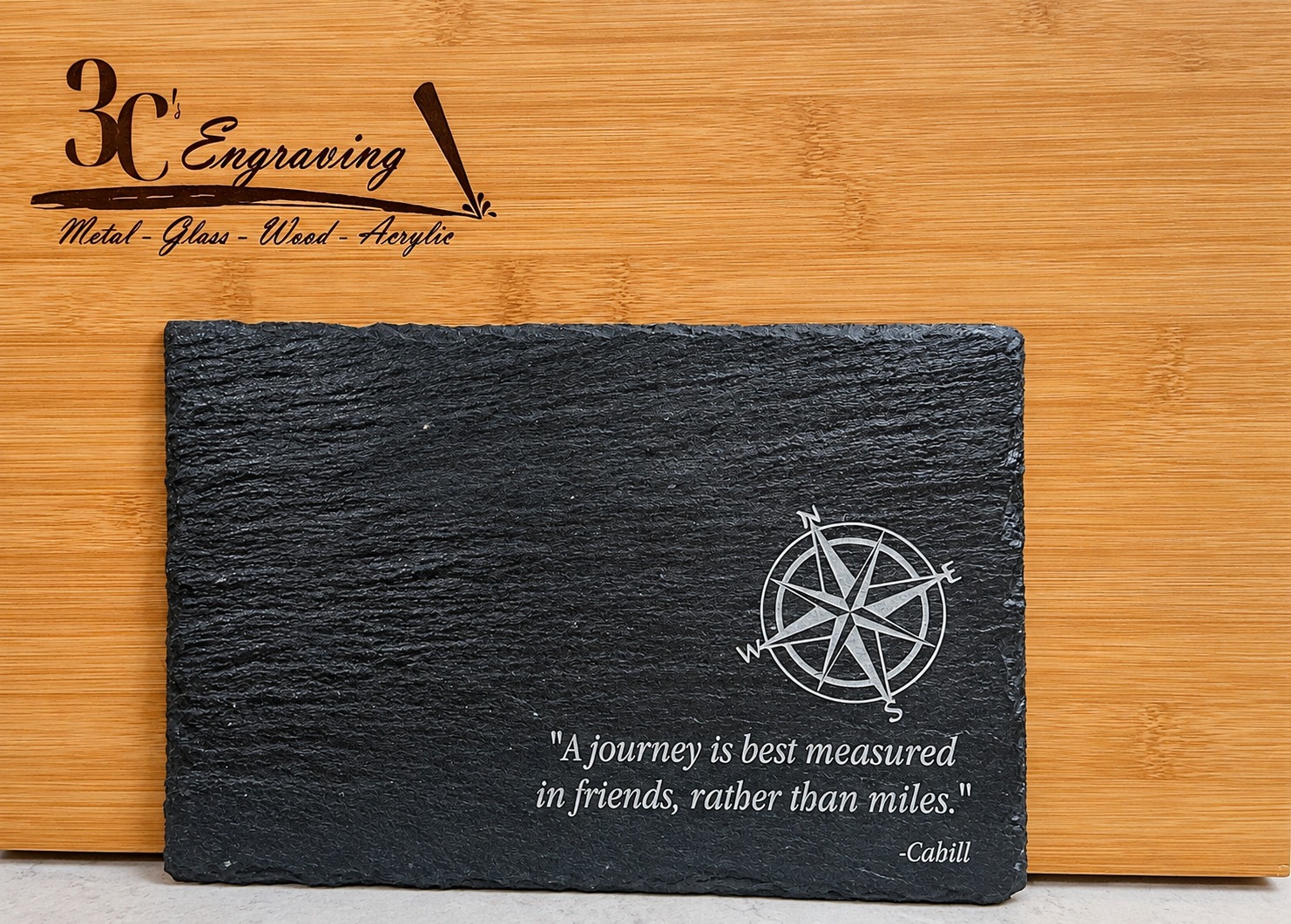 Engraved slate serving board with compass and friendship quote