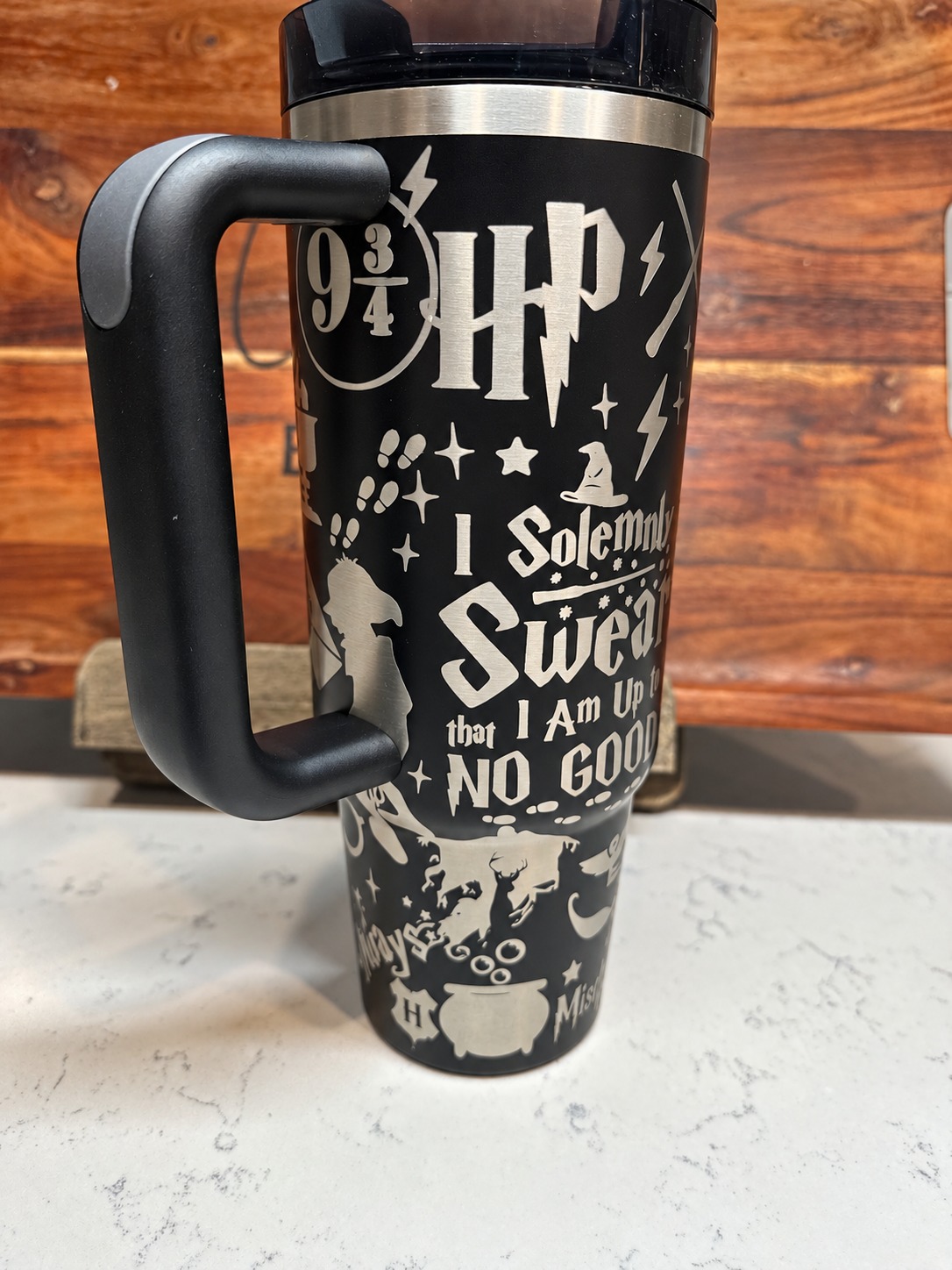 Black handled tumbler with a detailed wizard themed engraved wrap