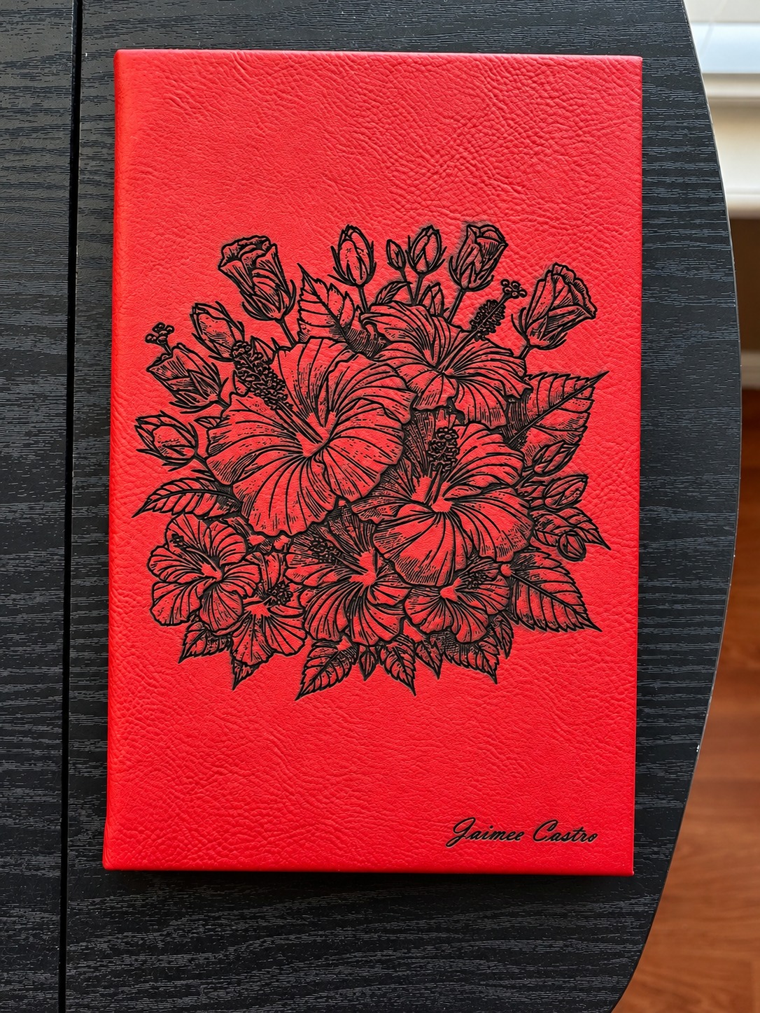 Red leatherette journal with custom hibiscus floral engraving and personalized name