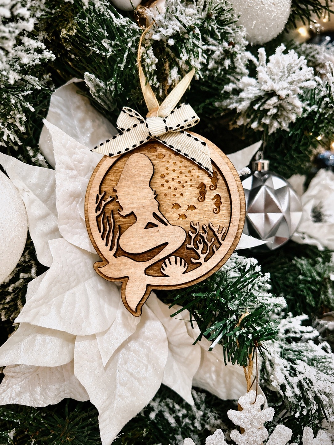Layered wooden mermaid ornament hanging on a Christmas tree